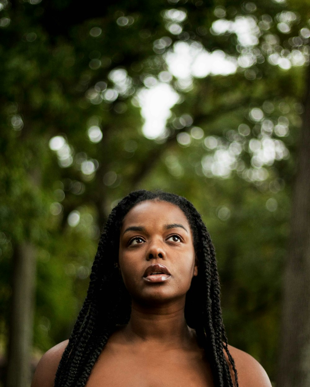 A woman standing outdoors, looking ahead